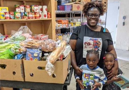 single mom with donated groceries and 2 small children